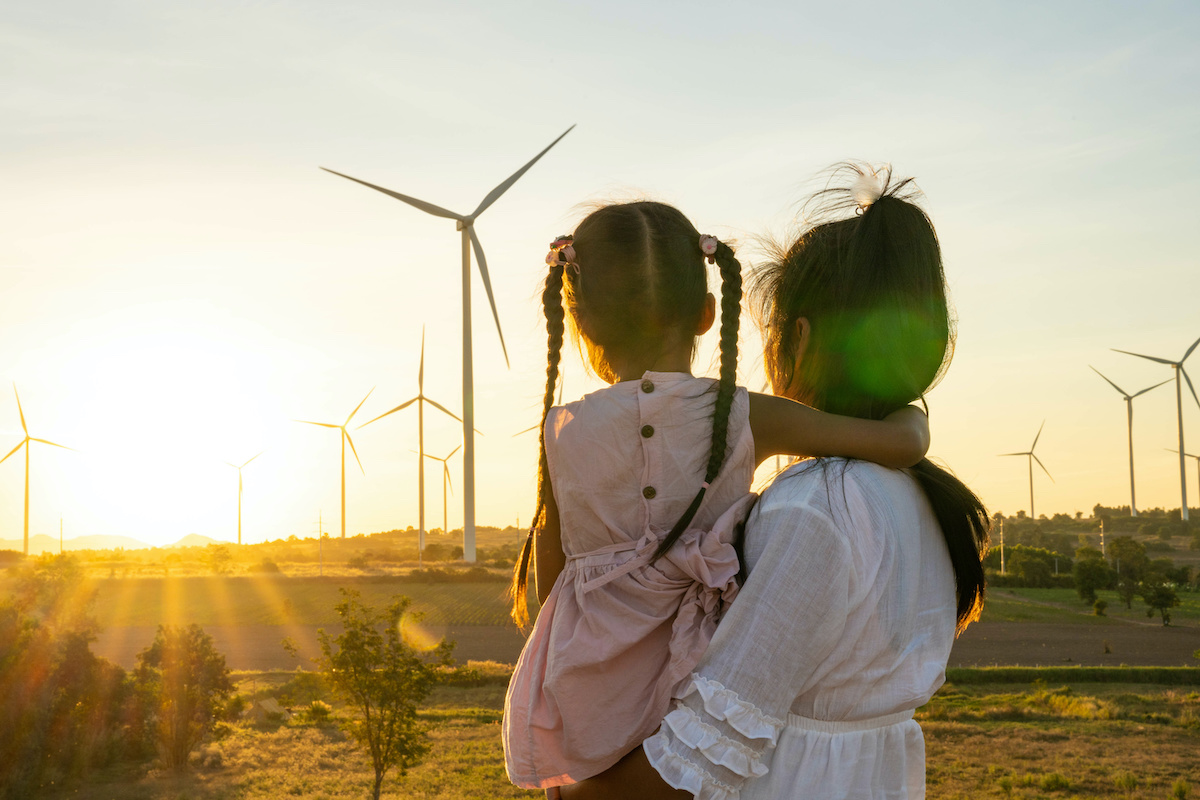 Woman and Child Looking at Wind Turbines